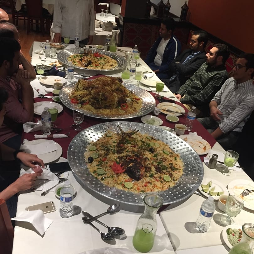 Diners at Marib Restaurant share large platters of middle-eastern rice dishes with meat and fish.